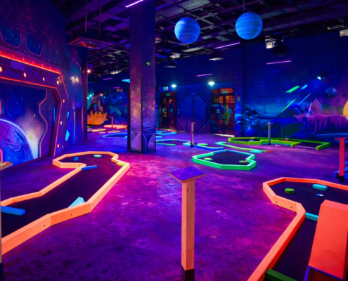 Black light glow mini golf concept with space theme