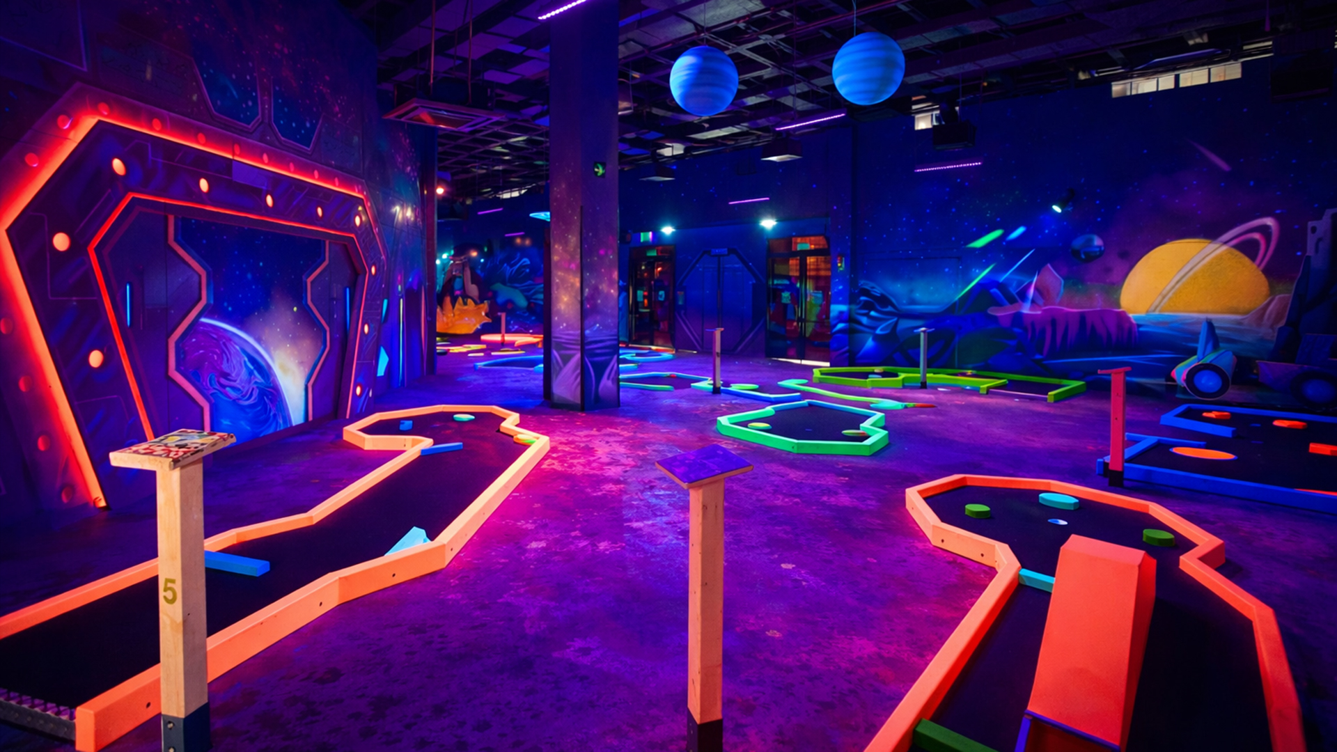 Black light glow mini golf concept with space theme
